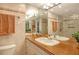 Elegant bathroom with dual sinks and a large mirror at 6047 E Peppertree Way # 224, Sarasota, FL 34242