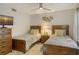 Charming bedroom with twin beds and a ceiling fan at 6047 E Peppertree Way # 224, Sarasota, FL 34242
