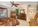 Bright bedroom with two twin beds, and ceiling fan at 6047 E Peppertree Way # 224, Sarasota, FL 34242