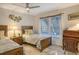 Cozy bedroom with twin beds, ceiling fan, and window at 6047 E Peppertree Way # 224, Sarasota, FL 34242