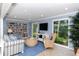 Common area with comfortable seating, bookshelves, and large windows at 6047 E Peppertree Way # 224, Sarasota, FL 34242