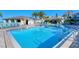 Inviting community pool with lounge chairs and patio area at 6047 E Peppertree Way # 224, Sarasota, FL 34242