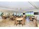Spacious community room with tables, chairs, and ocean views at 6047 E Peppertree Way # 224, Sarasota, FL 34242