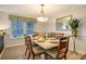 Bright dining room with a table set for six and a large mirror at 6047 E Peppertree Way # 224, Sarasota, FL 34242
