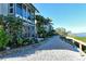 Landscaped pathway leading to waterfront property with tropical foliage at 6047 E Peppertree Way # 224, Sarasota, FL 34242