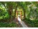 Inviting pathway through lush tropical landscaping at 6047 E Peppertree Way # 224, Sarasota, FL 34242