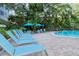 Relaxing pool area with plenty of lounge chairs at 6047 E Peppertree Way # 224, Sarasota, FL 34242