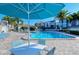 Relaxing pool area with patio furniture and umbrellas at 6047 E Peppertree Way # 224, Sarasota, FL 34242