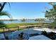 Stunning water view from patio, featuring a table and chairs at 6047 E Peppertree Way # 224, Sarasota, FL 34242