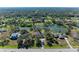 Aerial view of home on a lake with surrounding houses at 6300 26Th E Ave, Bradenton, FL 34208