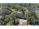 Aerial view of a house nestled amongst trees near a lake at 6300 26Th E Ave, Bradenton, FL 34208