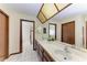 Bathroom boasts double vanity, a large mirror, and an adjacent shower at 6300 26Th E Ave, Bradenton, FL 34208