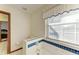 Simple bathroom with toilet, bathtub, and window with blinds at 6300 26Th E Ave, Bradenton, FL 34208
