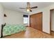 Bedroom with hardwood floors, double doors, and a ceiling fan at 6300 26Th E Ave, Bradenton, FL 34208