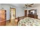 Bright bedroom with wood flooring, ceiling fan, and built-in dresser at 6300 26Th E Ave, Bradenton, FL 34208