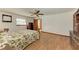 Cozy bedroom with floral bedding, wood floors, and ceiling fan at 6300 26Th E Ave, Bradenton, FL 34208