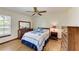 Bedroom with wood floors, a ceiling fan, and a dresser at 6300 26Th E Ave, Bradenton, FL 34208