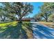 Brick ranch home with large yard, mature trees, and long driveway at 6300 26Th E Ave, Bradenton, FL 34208