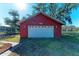 Detached red garage with white door at 6300 26Th E Ave, Bradenton, FL 34208