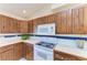 Kitchen with wood cabinets and white appliances at 6300 26Th E Ave, Bradenton, FL 34208
