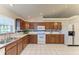 Kitchen with wood cabinets and white appliances at 6300 26Th E Ave, Bradenton, FL 34208