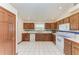 Spacious kitchen with wood cabinets, white appliances, and tile floor at 6300 26Th E Ave, Bradenton, FL 34208