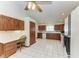 Kitchen with wood cabinets, built-in desk, and tile floor at 6300 26Th E Ave, Bradenton, FL 34208