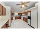 Large kitchen with wood cabinets, white appliances, and tile floor at 6300 26Th E Ave, Bradenton, FL 34208