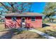 Small red storage shed with a door at 6300 26Th E Ave, Bradenton, FL 34208