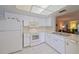 White kitchen features ample cabinetry and appliances at 6304 Pointe West Blvd # A306, Bradenton, FL 34209