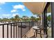 Private balcony overlooking parking and trees at 6326 Midnight Pass Rd # 101, Sarasota, FL 34242