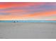 Scenic beach view at sunset with people at 6326 Midnight Pass Rd # 101, Sarasota, FL 34242