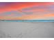 Peaceful beach view at sunset, featuring footprints in the sand and ocean waves at 6326 Midnight Pass Rd # 101, Sarasota, FL 34242
