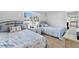 Guest bedroom with two twin beds and blue bedding at 6326 Midnight Pass Rd # 101, Sarasota, FL 34242