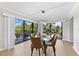 Modern dining area with glass table and leather chairs, near sliding glass doors at 6326 Midnight Pass Rd # 101, Sarasota, FL 34242
