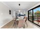 Modern dining area with glass table and kitchen access at 6326 Midnight Pass Rd # 101, Sarasota, FL 34242