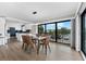 Open dining area with a glass table and kitchen view at 6326 Midnight Pass Rd # 101, Sarasota, FL 34242