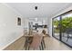 Modern dining room with glass table and access to balcony at 6326 Midnight Pass Rd # 101, Sarasota, FL 34242