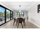 Bright dining room with glass table and balcony access at 6326 Midnight Pass Rd # 101, Sarasota, FL 34242