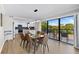 Elegant dining area with glass table and kitchen view at 6326 Midnight Pass Rd # 101, Sarasota, FL 34242