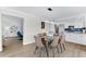 Dining room with glass table and leather chairs, kitchen view at 6326 Midnight Pass Rd # 101, Sarasota, FL 34242
