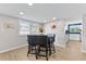 Cozy dining area with a dark wood table and four black leather chairs at 6326 Midnight Pass Rd # 101, Sarasota, FL 34242