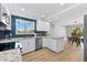 Updated kitchen with white cabinets, granite countertops and blue tile backsplash at 6326 Midnight Pass Rd # 101, Sarasota, FL 34242