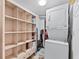 Convenient laundry area with washer, dryer, and shelving at 6326 Midnight Pass Rd # 101, Sarasota, FL 34242
