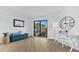 Bright living room with sliding doors to balcony and coastal decor at 6326 Midnight Pass Rd # 101, Sarasota, FL 34242