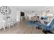 Living area showcasing a white accent wall and large clock at 6326 Midnight Pass Rd # 101, Sarasota, FL 34242