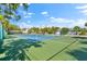 Tennis and pickleball courts with green surface and surrounding fence at 6326 Midnight Pass Rd # 101, Sarasota, FL 34242