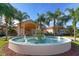 Stunning clubhouse entrance with circular fountain and palm trees at 6422 42Nd E St, Sarasota, FL 34243