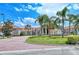 Elegant community clubhouse with palm trees and fountain at 6422 42Nd E St, Sarasota, FL 34243