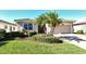 Single-story home with a two-car garage and landscaped front yard at 6422 42Nd E St, Sarasota, FL 34243